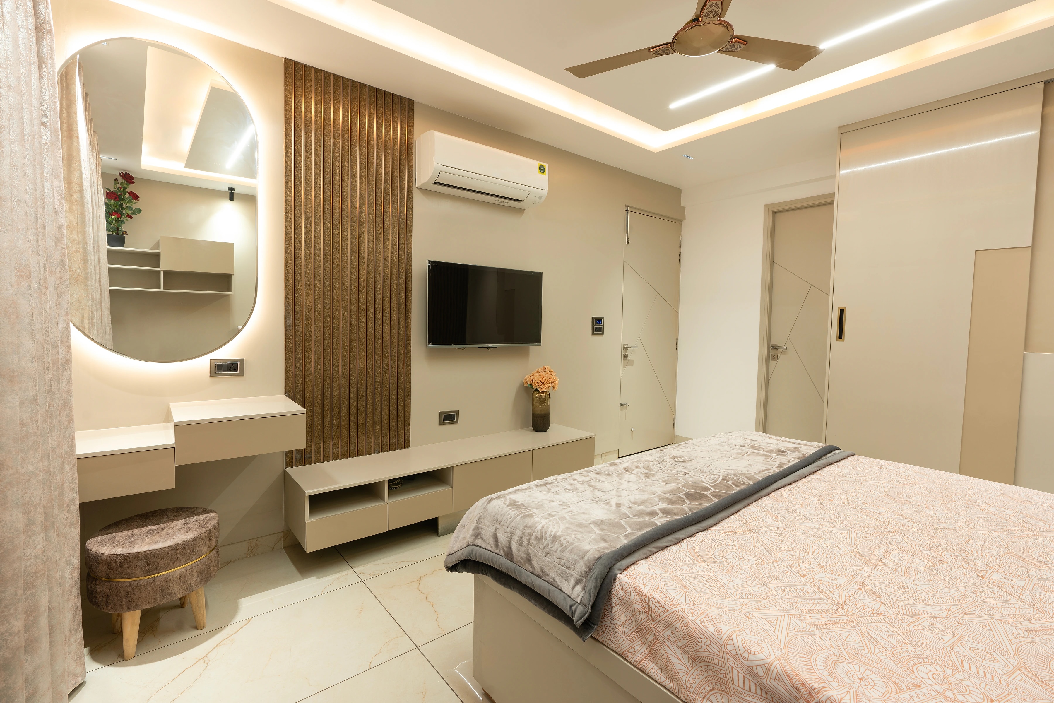 Apartment bedroom with television and vanity wall